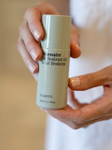 woman's hands holding necessaire deodorant gel.
